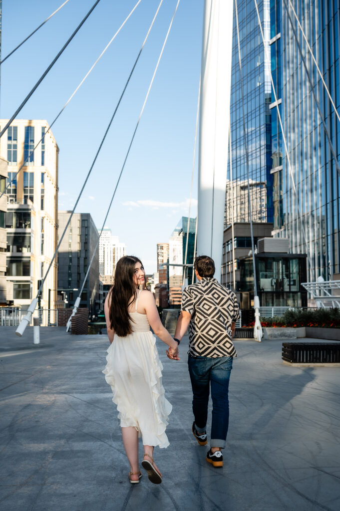 Couple strolling across the Millennium Bridge